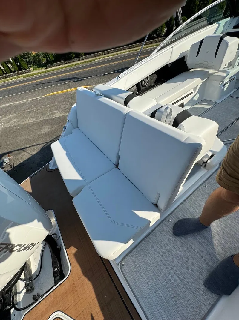 Slide: The Image of 2025 Four Winns H6 OB boat with white seating and deck view. - 31