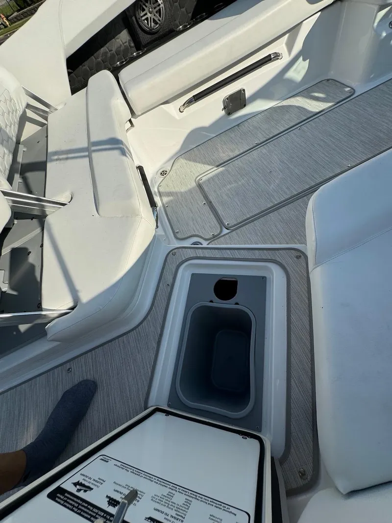 Slide: The Image of 2025 Four Winns H6 OB boat interior with seating and storage compartments. - 32