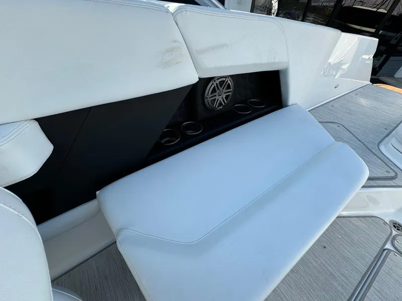 Slide: The Image of 2025 Four Winns H6 OB boat interior with white seating and built-in speaker. - 9