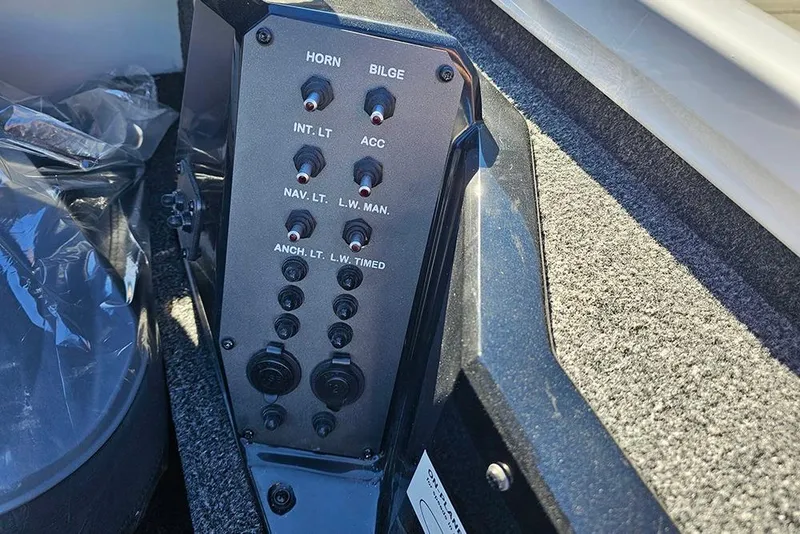 Slide: The Image of Control panel of 2026 Vexus Defender 189 boat, featuring various switches and buttons. - 13