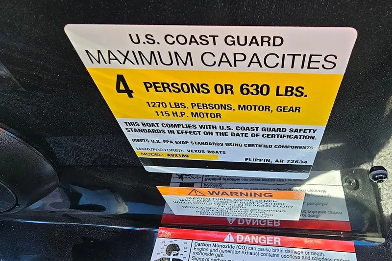 Slide: The Image of U.S. Coast Guard capacity label for Vexus Defender 189, 2026 model, 4 persons or 630 lbs. - 14
