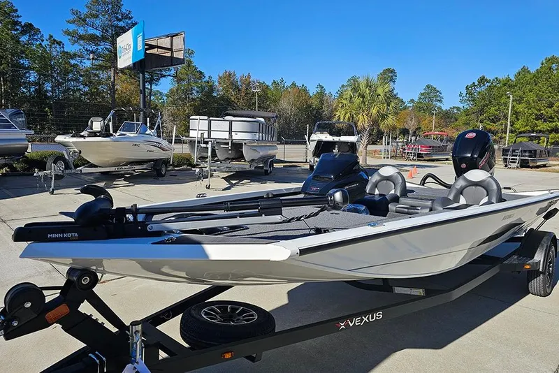 Slide: The Image of 2026 Vexus Defender 189 boat on trailer, parked outdoors at a dealership. - 5