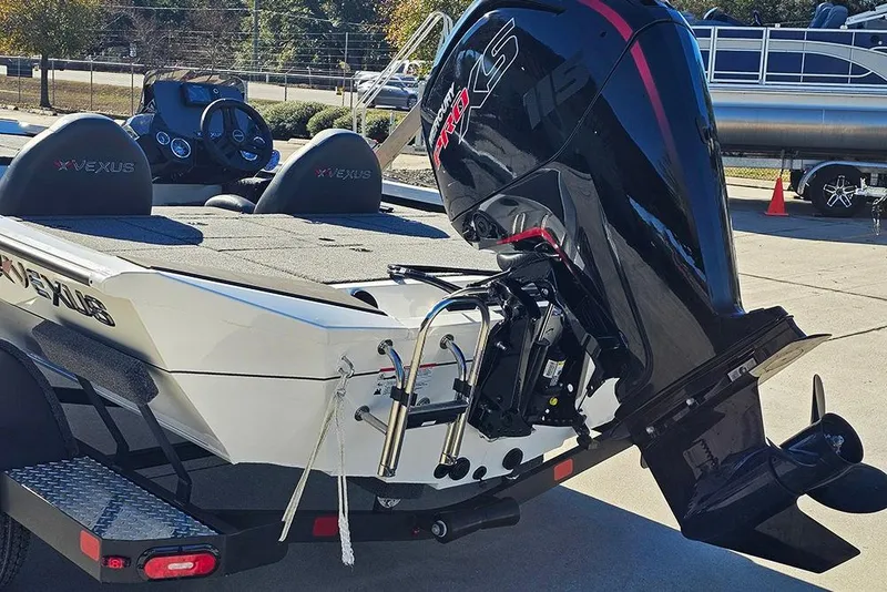 Slide: The Image of 2026 Vexus Defender 189 boat with powerful outboard motor in a parking lot. - 9