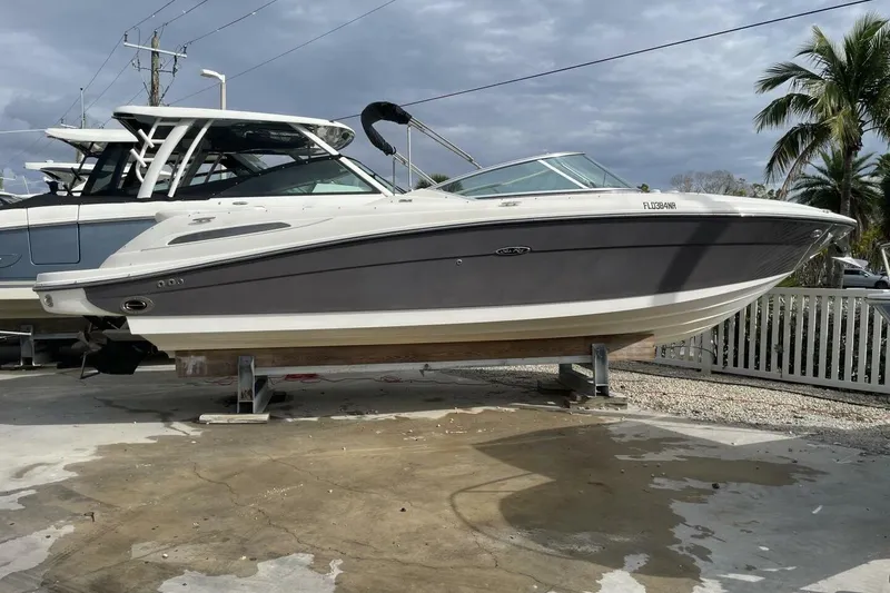 The Image of 2008 Sea Ray 270 SLX boat on display, gray and white, parked outdoors. - 0