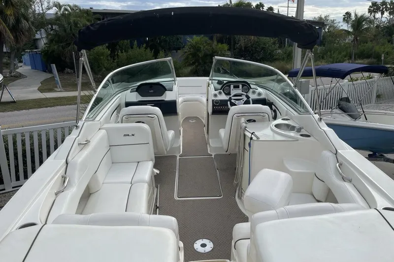 Slide: The Image of 2008 Sea Ray 270 SLX boat with white seating and sleek interior design. - 10