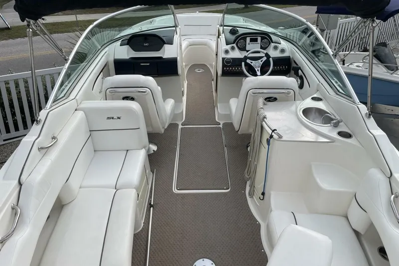 Slide: The Image of 2008 Sea Ray 270 SLX boat interior with white seating and modern dashboard. - 11