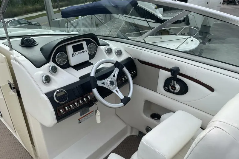 Slide: The Image of 2008 Sea Ray 270 SLX boat dashboard with steering wheel and navigation system. - 12