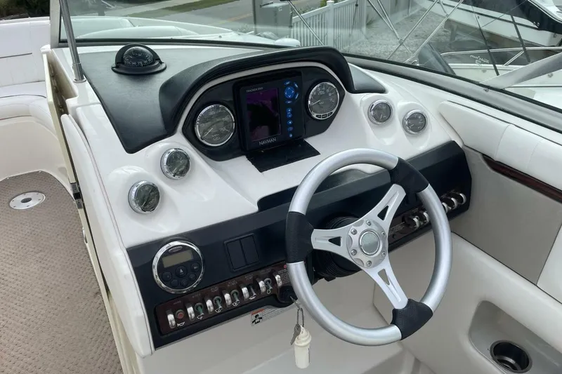 Slide: The Image of 2008 Sea Ray 270 SLX boat dashboard with steering wheel and navigation instruments. - 13
