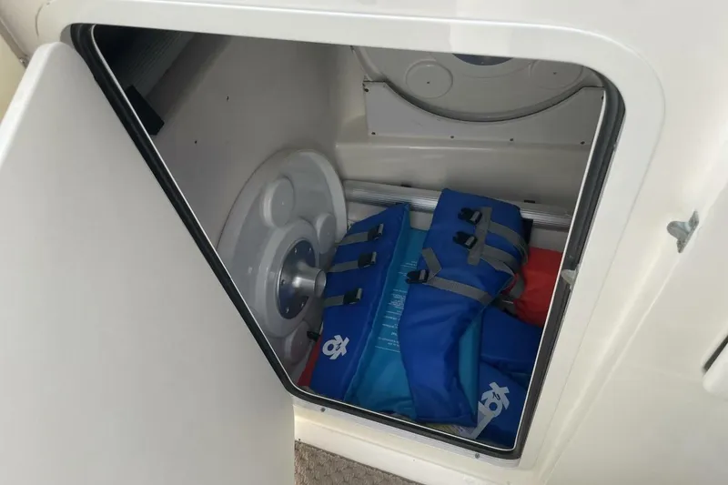 Slide: The Image of Storage compartment in 2008 Sea Ray 270 SLX boat with life jackets and equipment. - 15