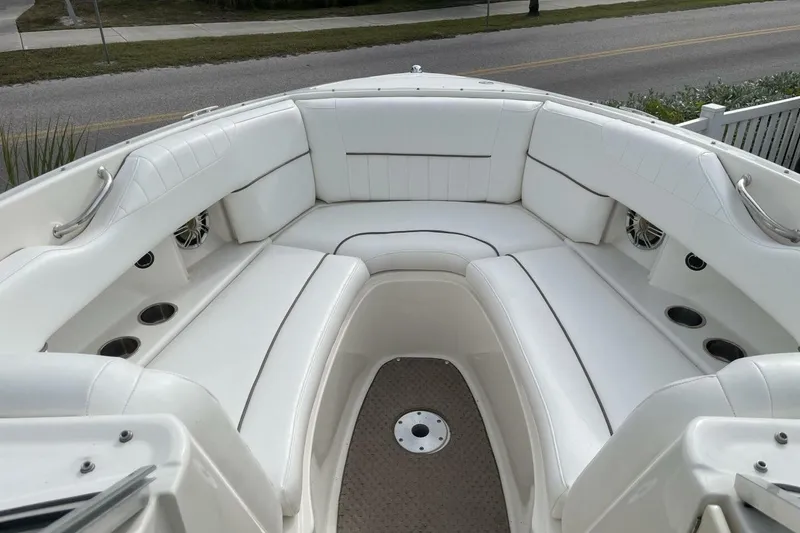 Slide: The Image of 2008 Sea Ray 270 SLX boat with spacious white seating and cup holders. - 16