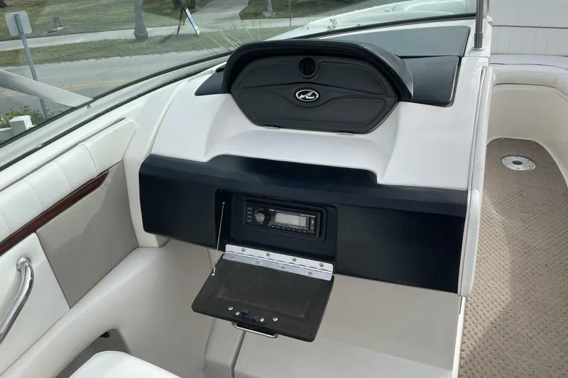 Slide: The Image of 2008 Sea Ray 270 SLX boat interior dashboard with stereo system and seating. - 17