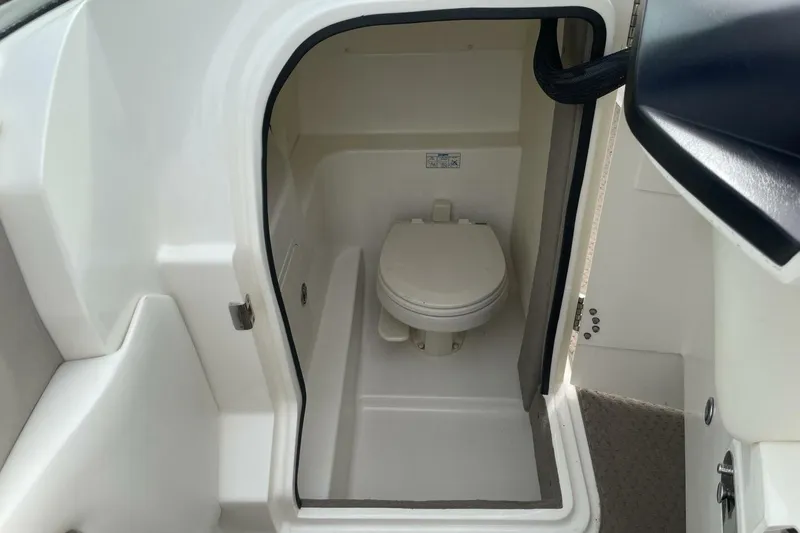Slide: The Image of 2008 Sea Ray 270 SLX boat interior with compact marine toilet. - 18