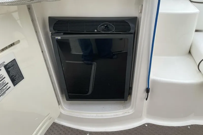 Slide: The Image of 2008 Sea Ray 270 SLX boat interior with compact refrigerator and white steps. - 20