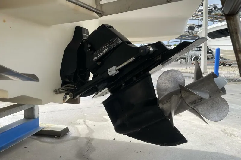 Slide: The Image of 2008 Sea Ray 270 SLX boat with MerCruiser outdrive and propeller, docked on a stand. - 33