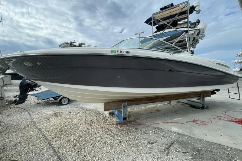 Slide: The Image of 2008 Sea Ray 270 SLX boat on dry dock under cloudy sky. - 4