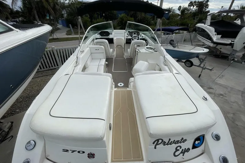Slide: The Image of 2008 Sea Ray 270 SLX boat with spacious seating and sleek design, docked outdoors. - 9