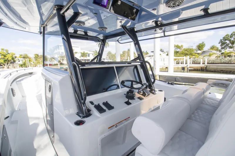 Slide: The Image of 2026 Yellowfin 42 Offshore boat dashboard with dual screens and steering wheel. - 12