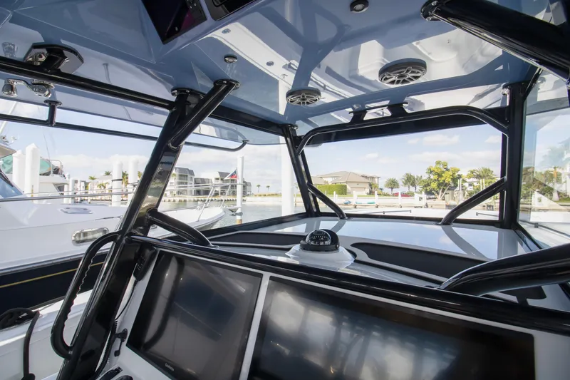 Slide: The Image of 2026 Yellowfin 42 Offshore boat dashboard with steering wheel and electronic controls. - 14
