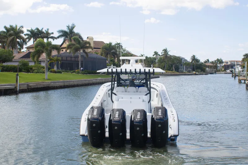 Slide: The Image of 2026 Yellowfin 42 Offshore boat with four engines cruising in a scenic waterway. - 3