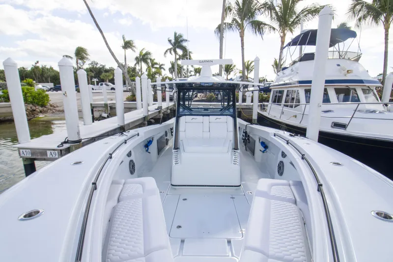 Slide: The Image of 2026 Yellowfin 42 Offshore boat storage compartment with open lid under a clear sky. - 7