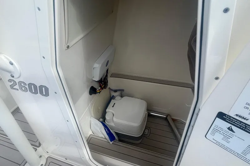 Slide: The Image of 2022 Pathfinder 2600 TRS boat interior with compact marine toilet. - 10