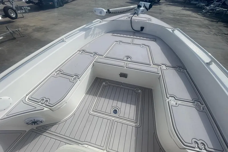 Slide: The Image of 2022 Pathfinder 2600 TRS boat deck with storage compartments and trolling motor. - 11