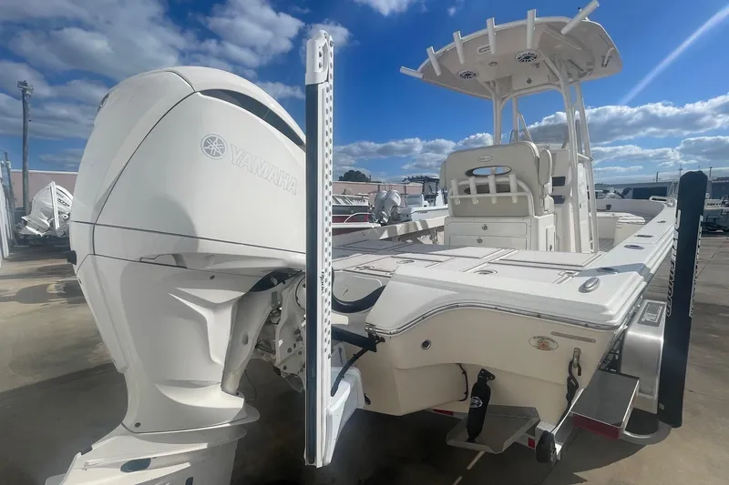 Slide: The Image of 2022 Pathfinder 2600 TRS boat with Yamaha engine, docked under a blue sky. - 3