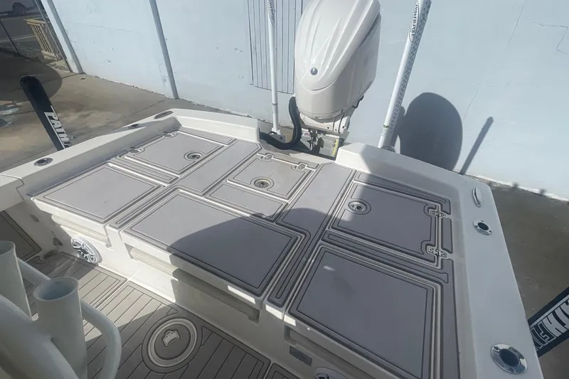 Slide: The Image of 2022 Pathfinder 2600 TRS boat deck with storage compartments and outboard motor. - 4