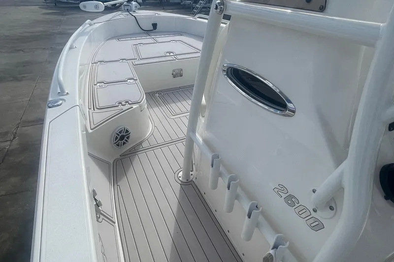 Slide: The Image of 2022 Pathfinder 2600 TRS boat interior with rod holders and deck details. - 8
