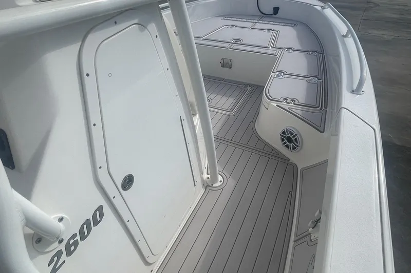 Slide: The Image of 2022 Pathfinder 2600 TRS boat interior with sleek deck design and storage compartments. - 9