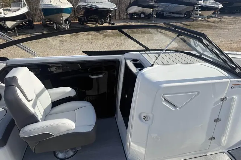 Slide: The Image of 2026 Yamaha Boats SX250 interior with white seating and sleek dashboard design. - 10