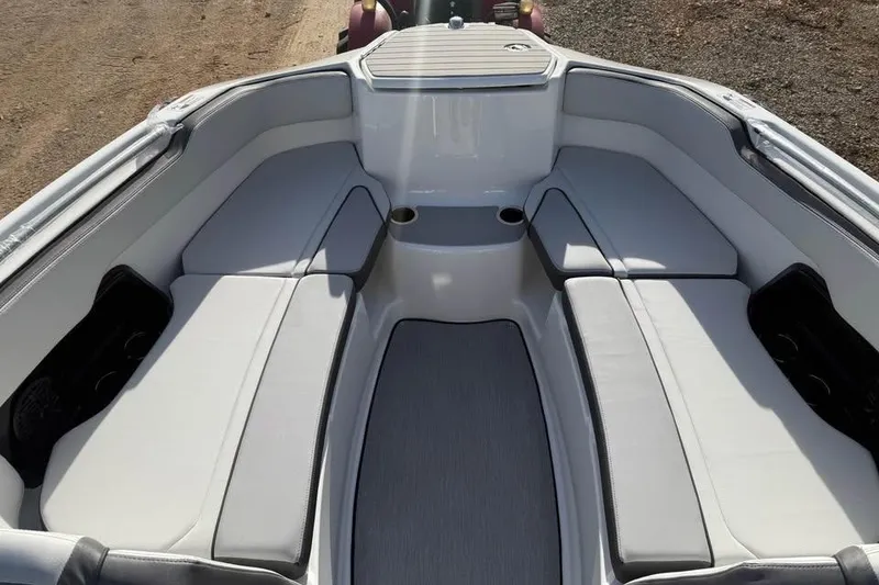 Slide: The Image of 2026 Yamaha Boats SX250 interior with spacious seating and cup holders. - 11