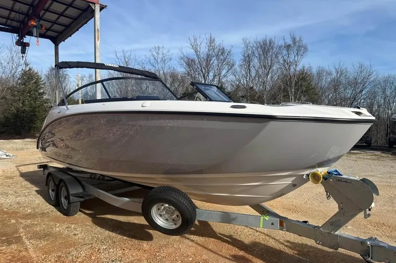 Slide: The Image of 2026 Yamaha Boats SX250 on trailer, parked outdoors under a clear sky. - 2