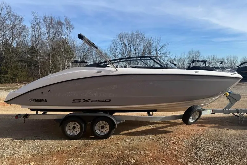 Slide: The Image of 2026 Yamaha Boats SX250 on trailer, parked outdoors, clear sky background. - 3