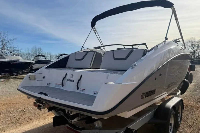 Slide: The Image of 2026 Yamaha Boats SX250 on trailer, rear view with sleek design and seating. - 4