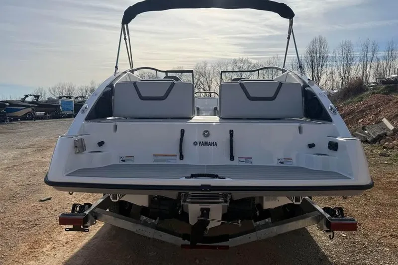 Slide: The Image of 2026 Yamaha Boats SX250, rear view, on trailer, outdoors. - 5