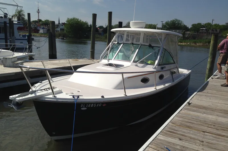 Slide: The Image of 2006 Back Cove 26 boat docked at a marina on a sunny day. - 0