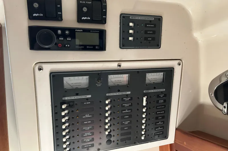 Slide: The Image of Control panel of a 2006 Back Cove 26 boat with switches and gauges. - 7