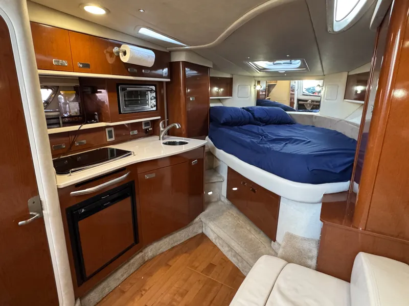 Slide: The Image of Interior of 2011 Sea Ray 330 Sundancer with kitchen and sleeping area. - 15