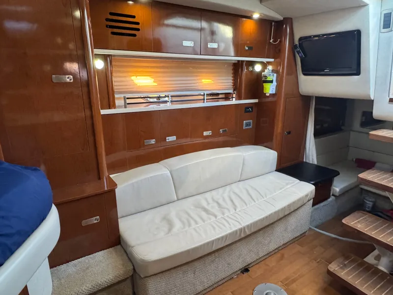 Slide: The Image of Interior of 2011 Sea Ray 330 Sundancer with sofa and wood paneling. - 16