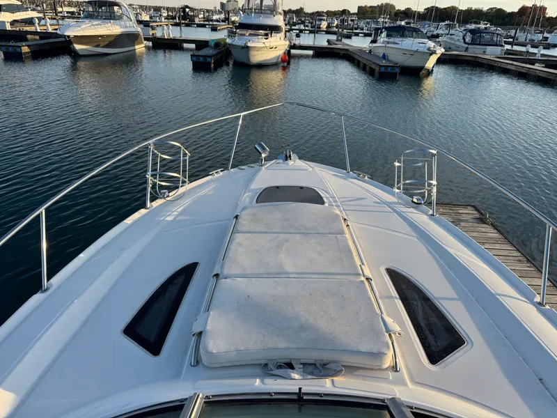 Slide: The Image of 2011 Sea Ray 330 Sundancer in marina, bow deck view. - 19