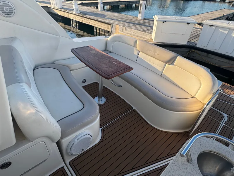 Slide: The Image of Interior of 2011 Sea Ray 330 Sundancer with seating area and table. - 2