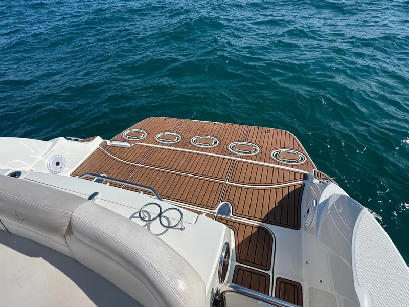 Slide: The Image of The 2011 Sea Ray Sundancer 330 features a spacious swim platform with wood-like finish and stainless steel railings. - 4