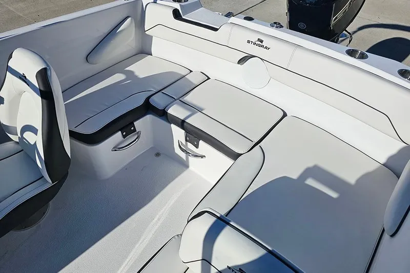 Slide: The Image of 2026 Stingray 172 DC boat interior with sleek white seating and modern design. - 12