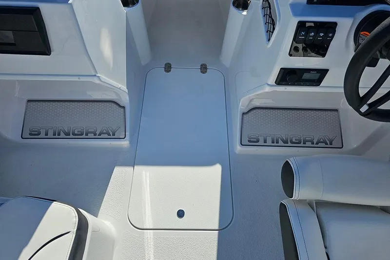 Slide: The Image of Interior view of 2026 Stingray 172 DC boat cockpit with branded floor mats. - 20