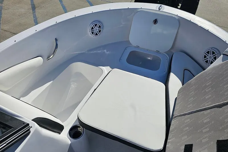 Slide: The Image of 2026 Stingray 172 DC boat interior with white seating and storage compartments. - 23