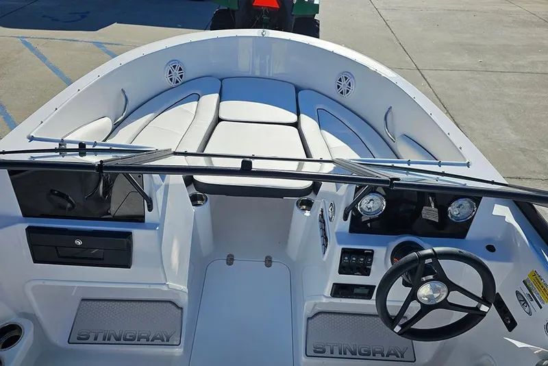 Slide: The Image of 2026 Stingray 172 DC boat interior with steering wheel, dashboard, and seating. - 25