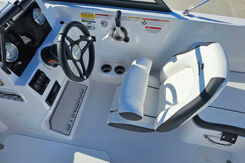 Slide: The Image of 2026 Stingray 172 DC boat interior with steering wheel and white seating. - 26