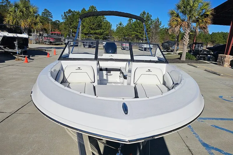 Slide: The Image of 2026 Stingray 172 DC boat with white interior, parked outdoors under clear blue sky. - 4
