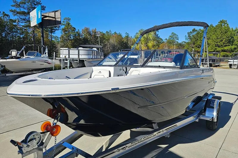 Slide: The Image of 2026 Stingray 172 DC boat on trailer, parked outdoors under clear blue sky. - 5